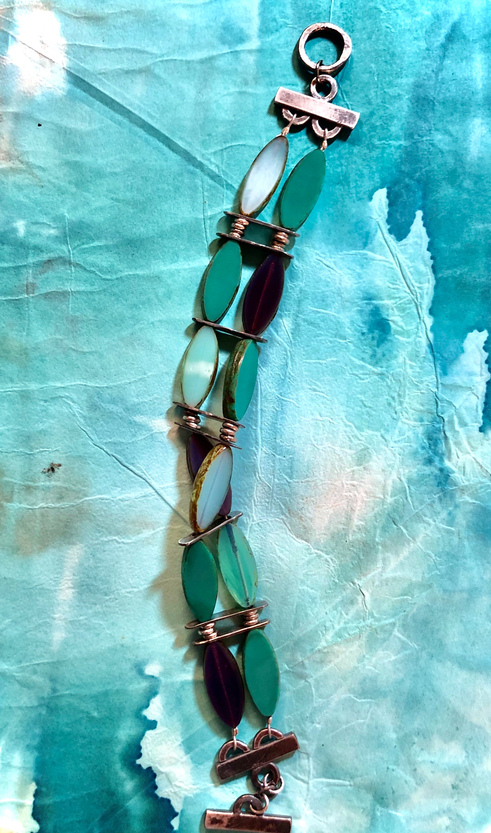 Handmade Elegant Aqua and purple vintage inspired glass beads accented by hand crafted silver.